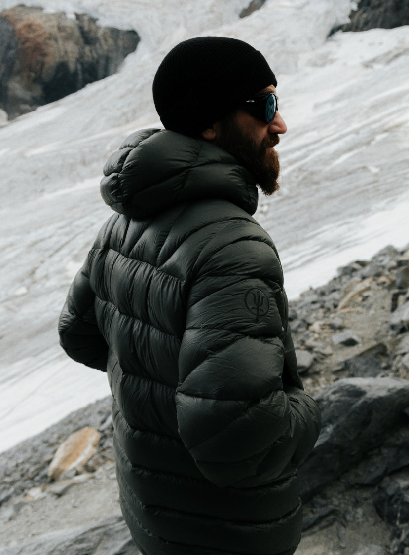 An in the field image of Men's Bastion Down Jacket in Forest Green (ITF)