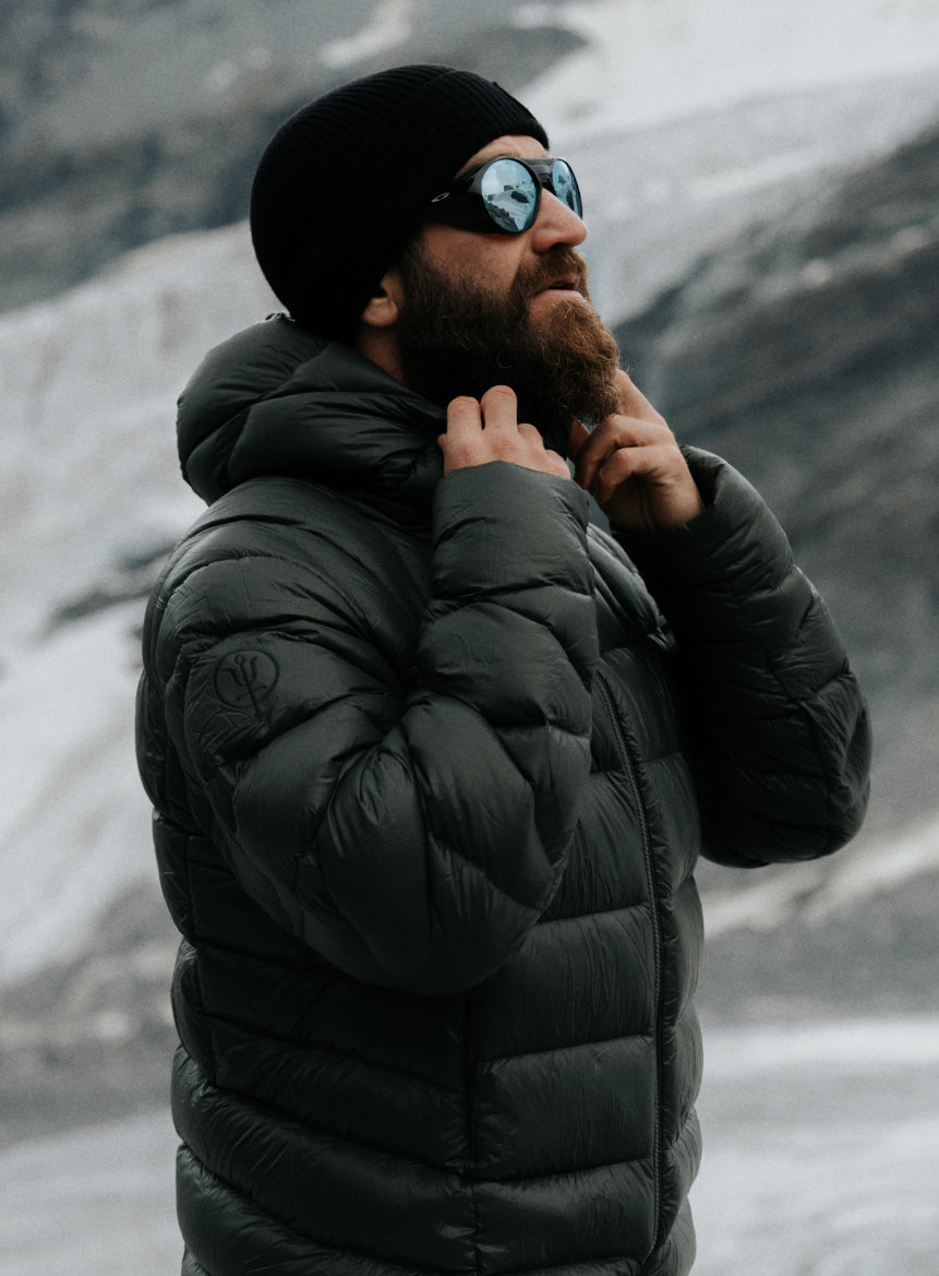 An in the field image of Men's Bastion Down Jacket in Forest Green (ITF)