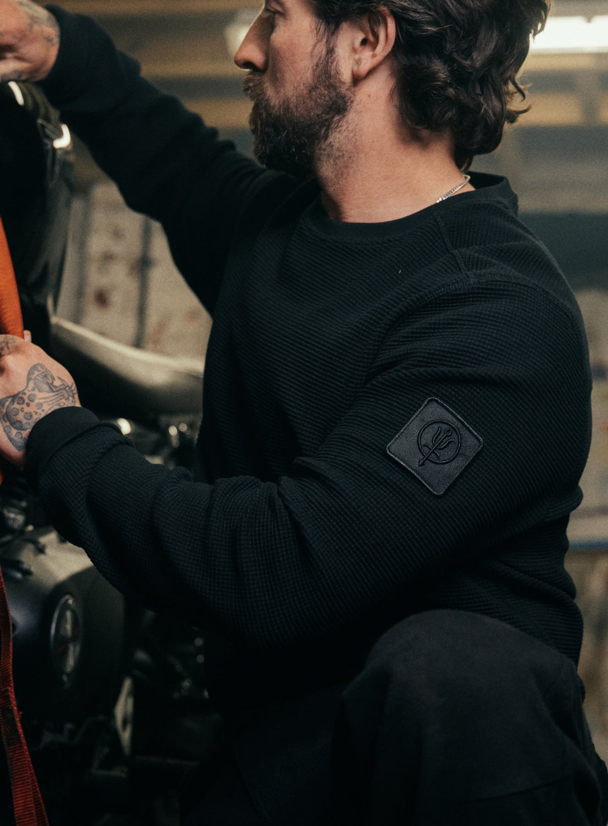An in the field image of Men's Dissident Waffle Long Sleeve T-Shirt in Obsidian Black (ITF)