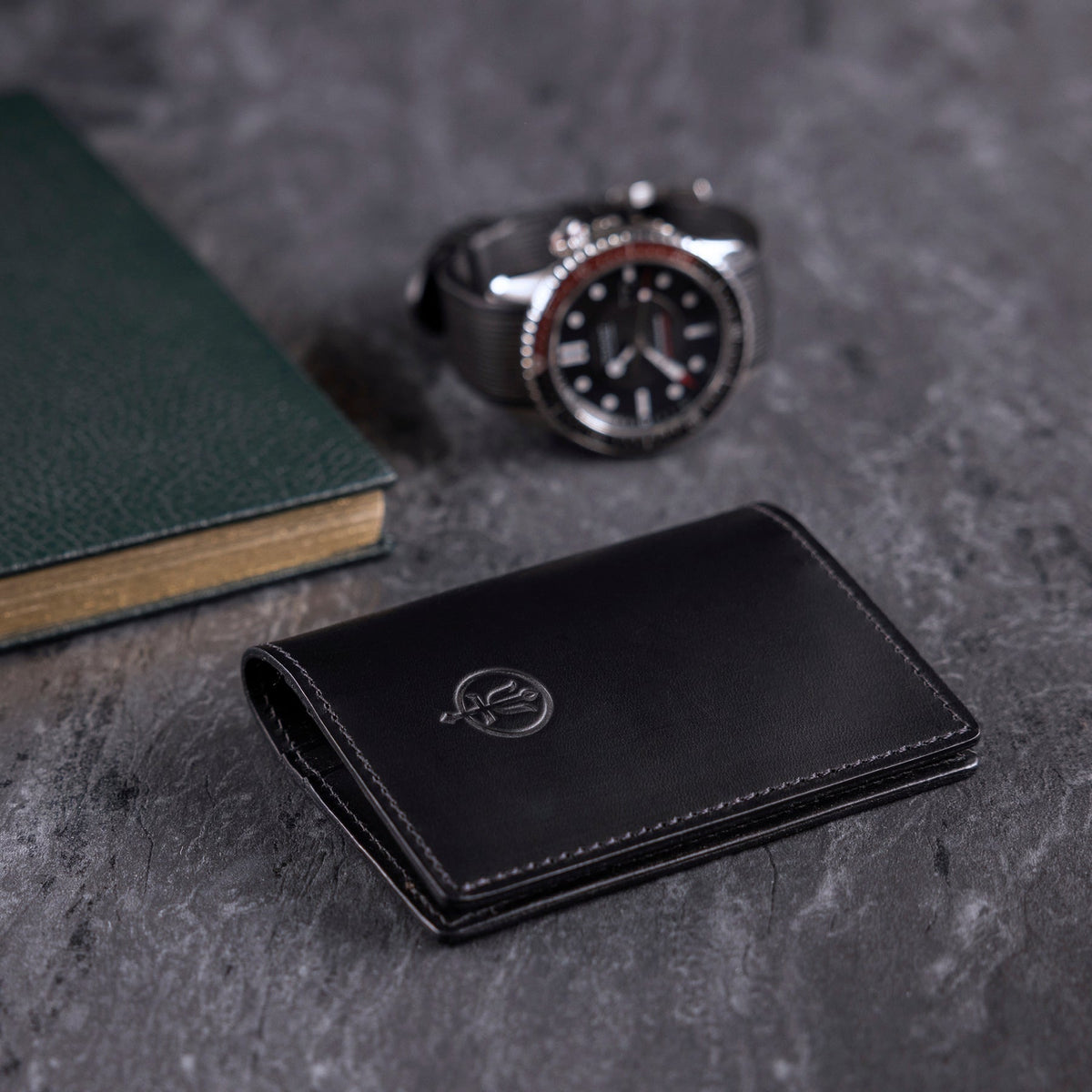 A creative studio shot of Leather Bi Fold Wallet in Black (CS)