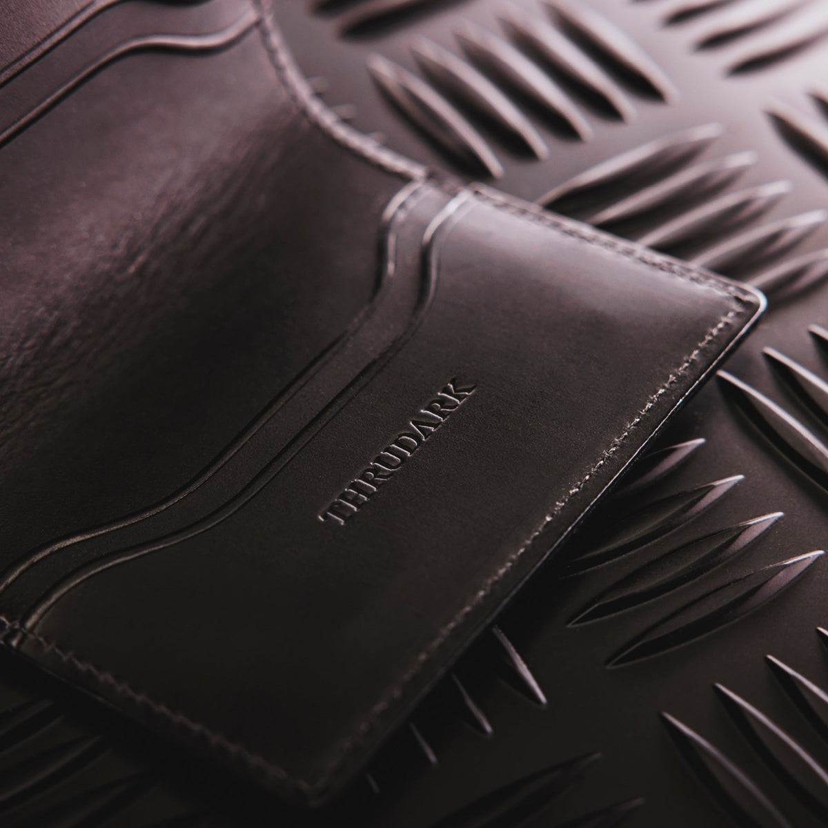 A creative studio shot of Leather Bi Fold Wallet in Black (CS)