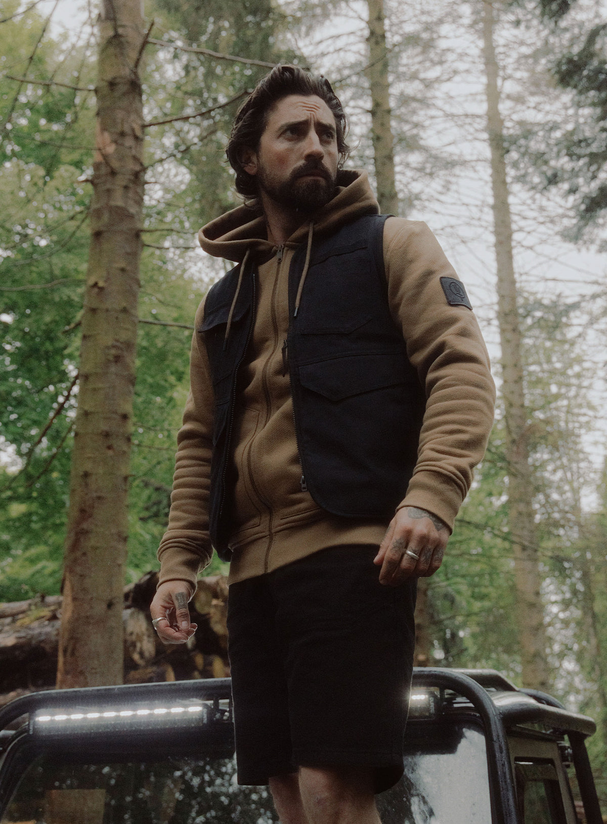 An in the field image of Men's Dissident Utility Vest in Obsidian Black (ITF)