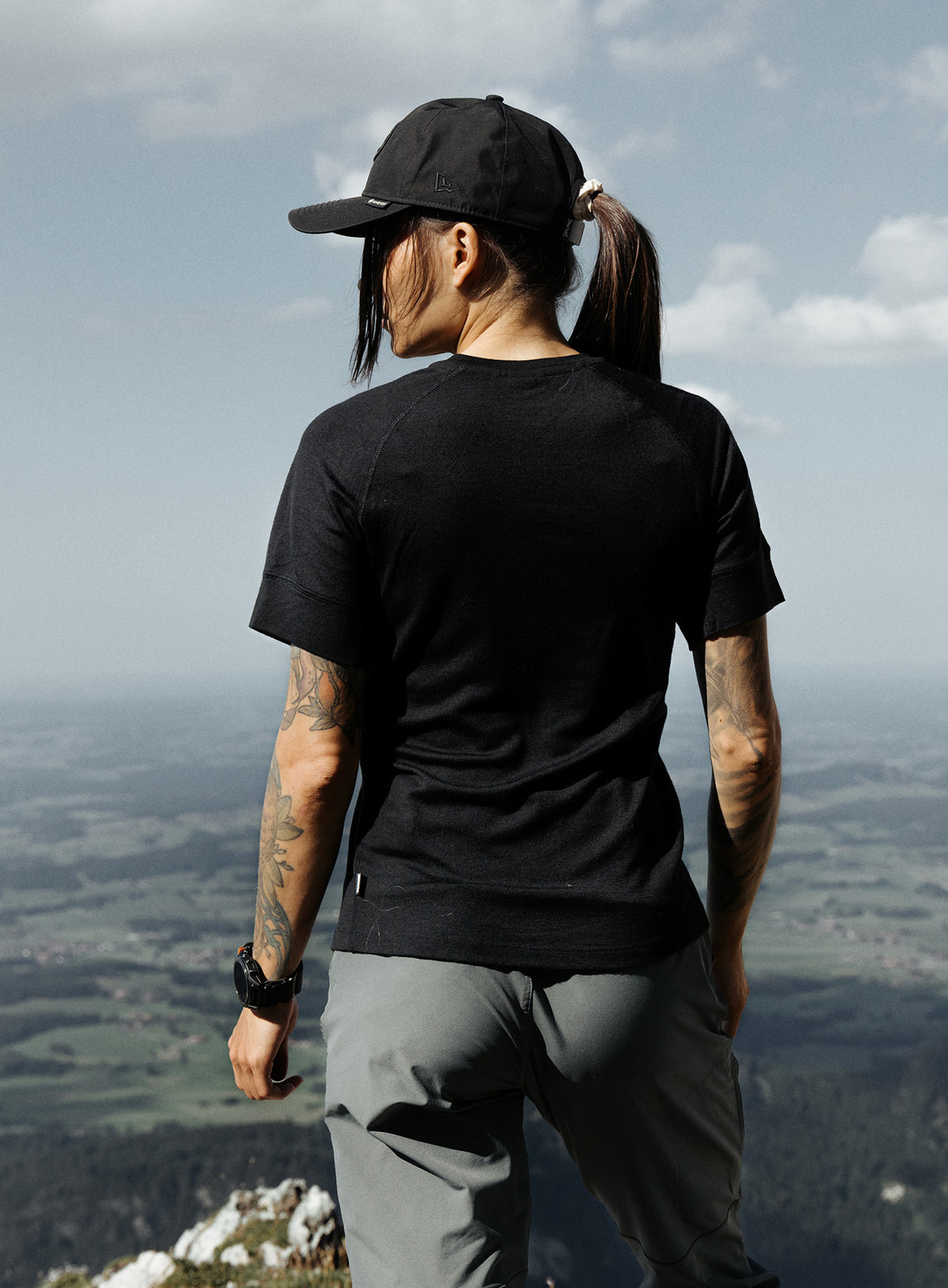 An in the field image of Women's Oryon 72HR Merino T-Shirt in Obsidian Black (ITF)