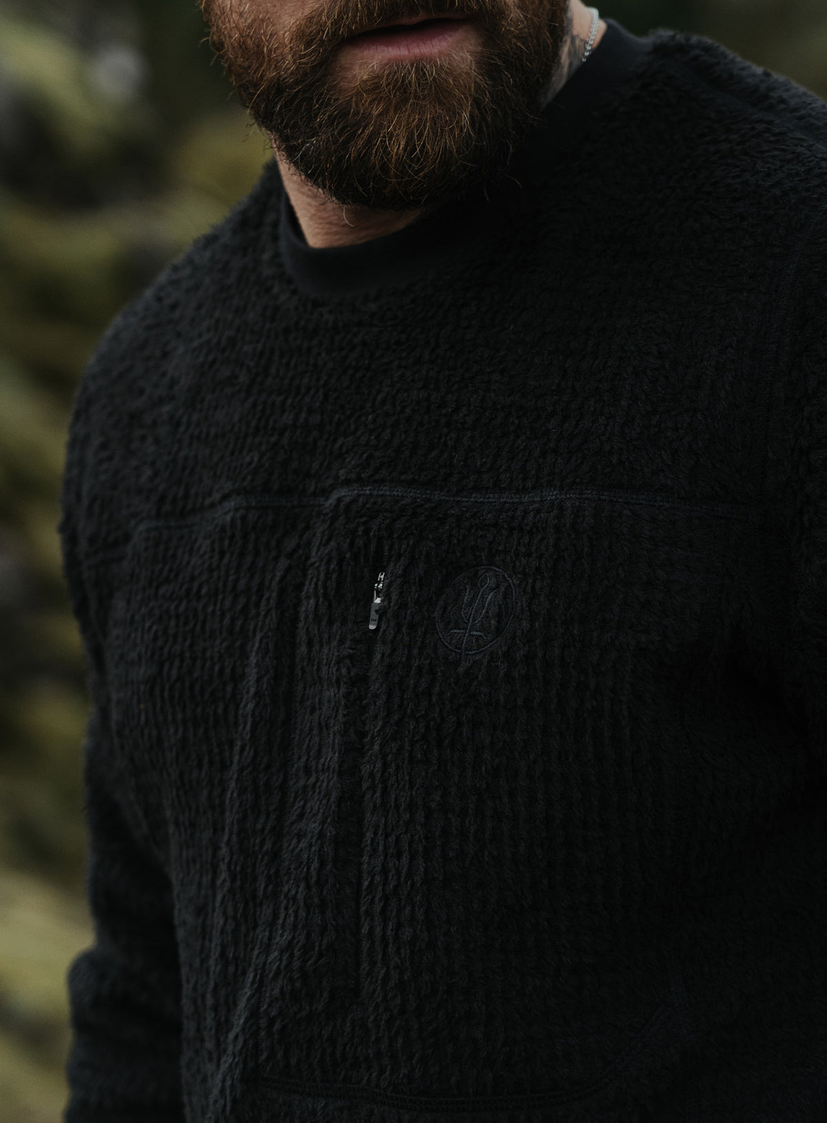 A creative studio shot of Phalanx Crew Fleece in Obsidian Black (CS)