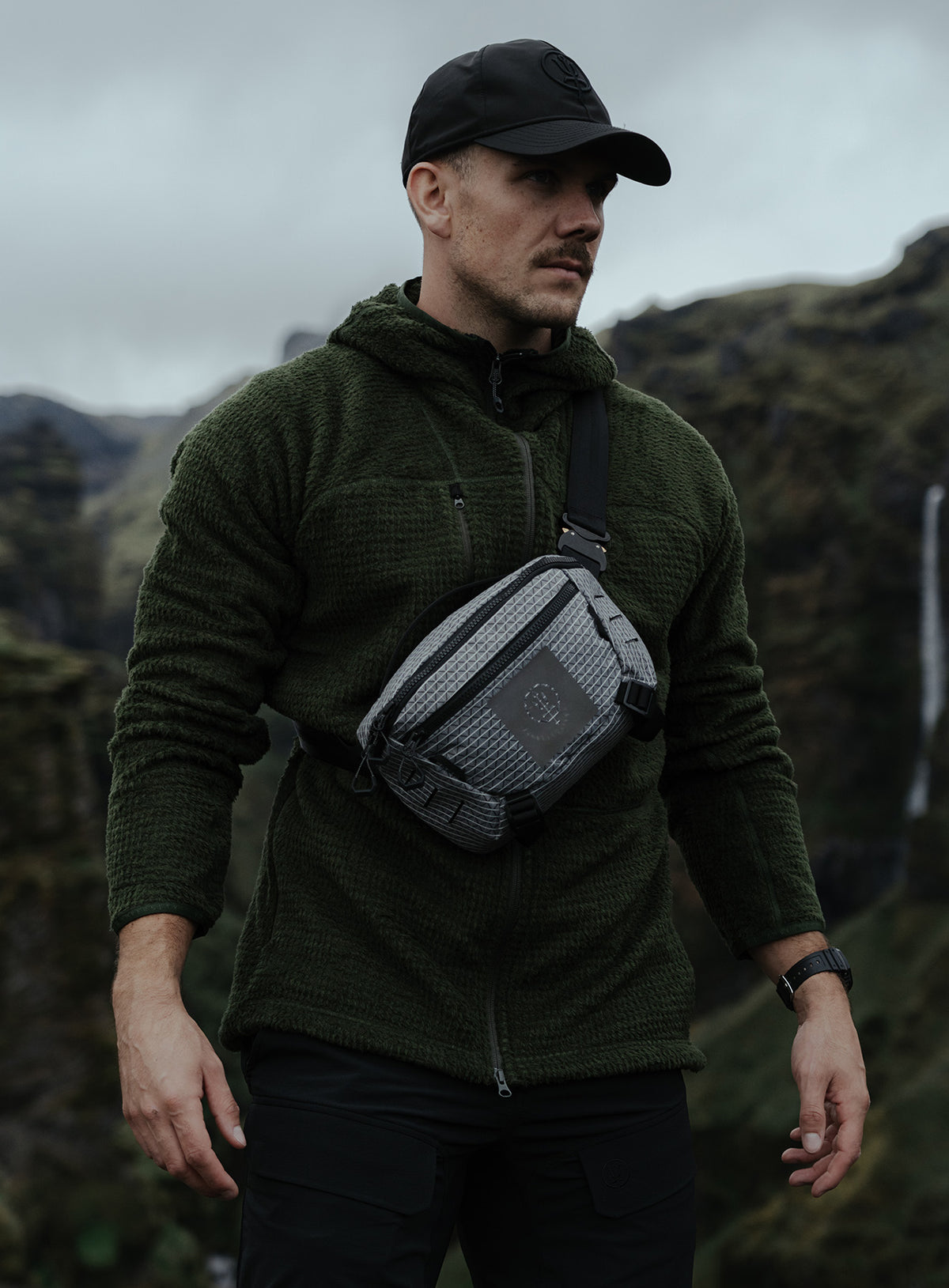 An in the field image of Phalanx Hooded Fleece in Forest Green (ITF)