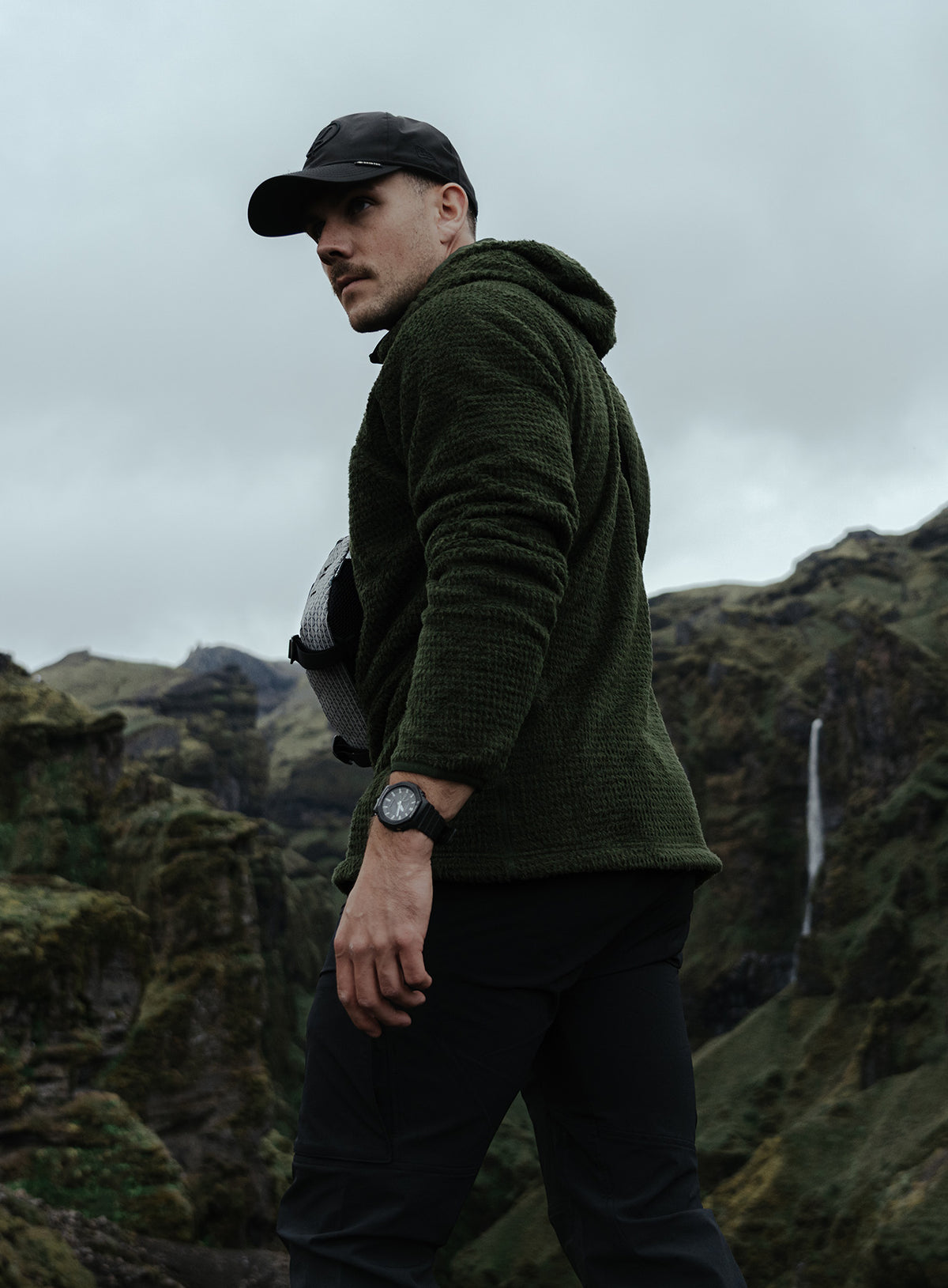 An in the field image of Phalanx Hooded Fleece in Forest Green (ITF)
