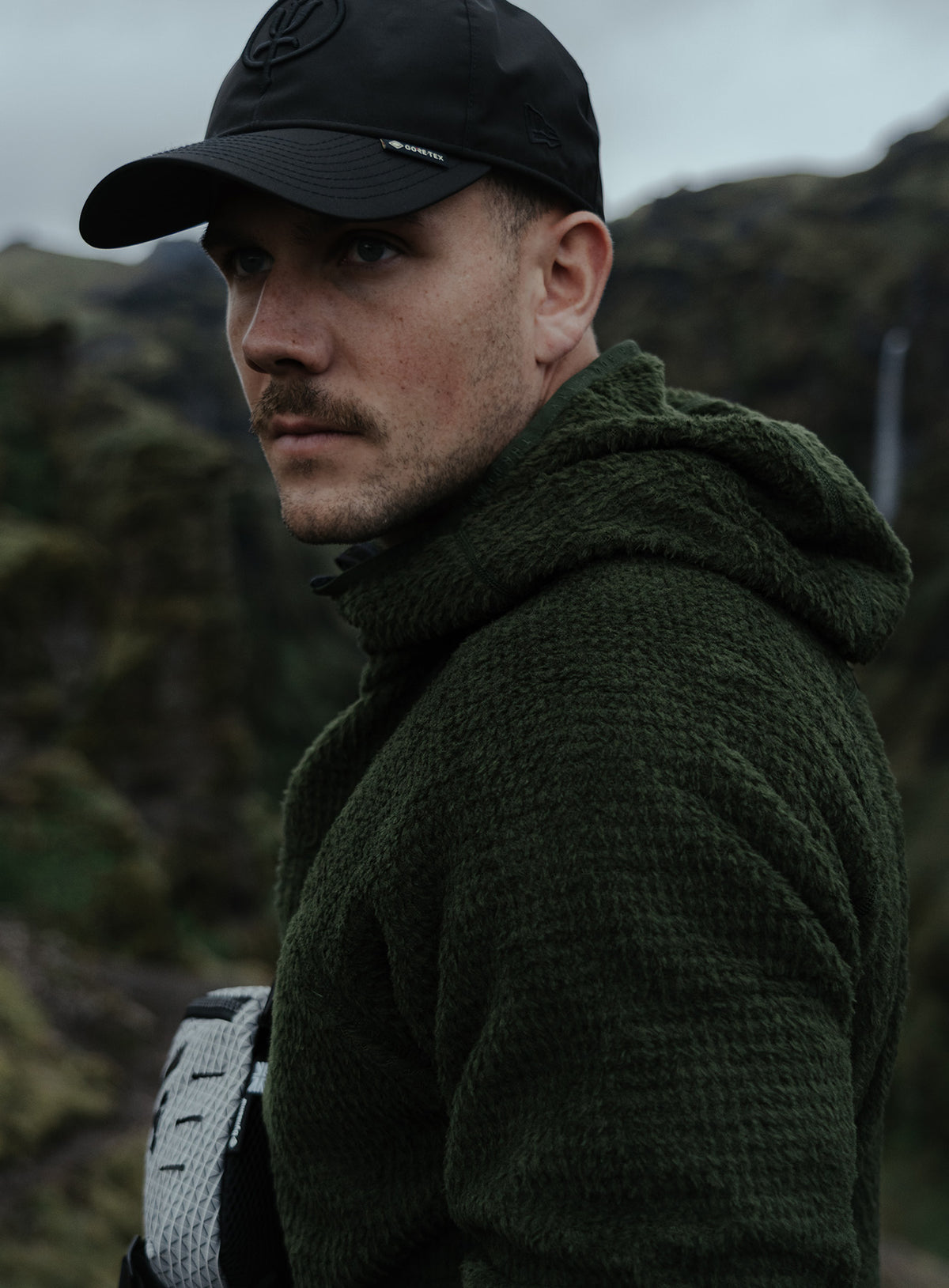 An in the field image of Phalanx Hooded Fleece in Forest Green (ITF)