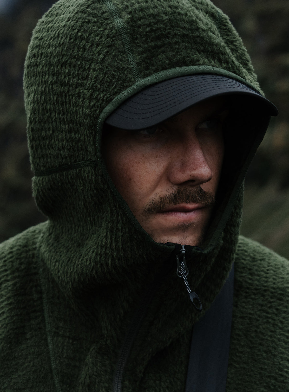 An in the field image of Phalanx Hooded Fleece in Forest Green (ITF)