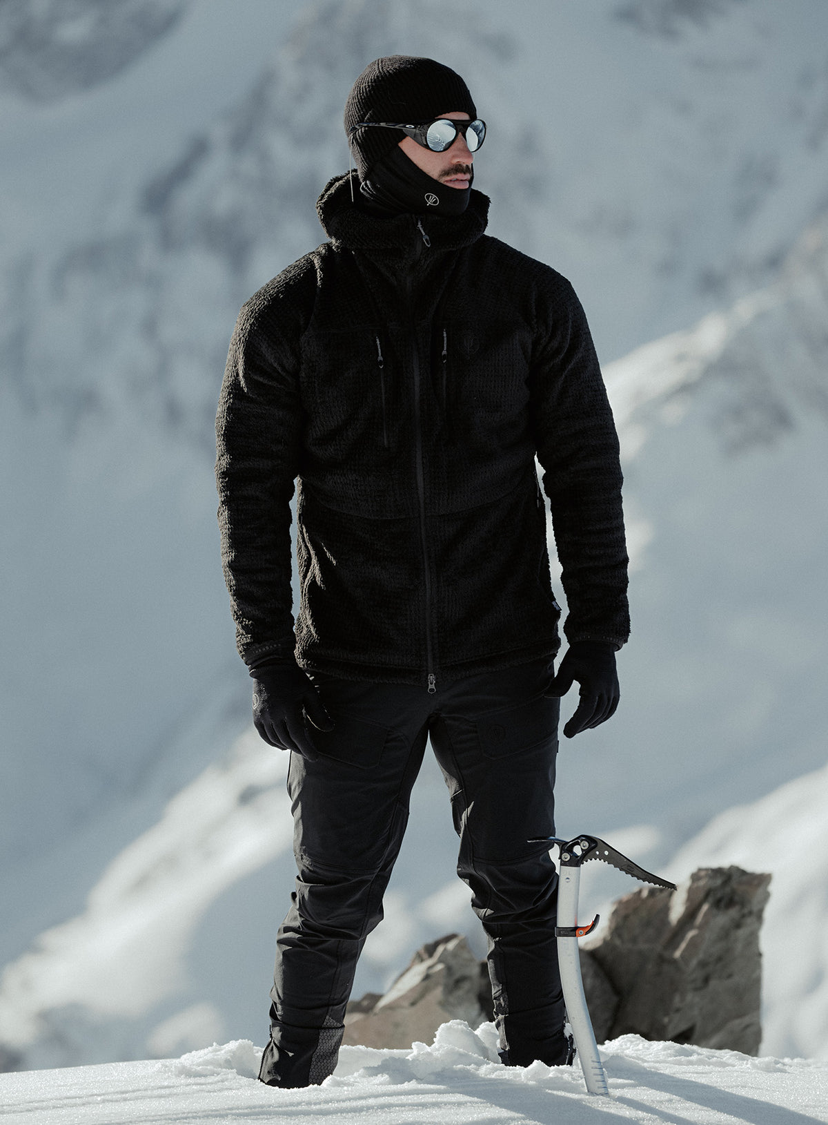An in the field image of Phalanx Hooded Fleece in Obsidian Black (ITF)