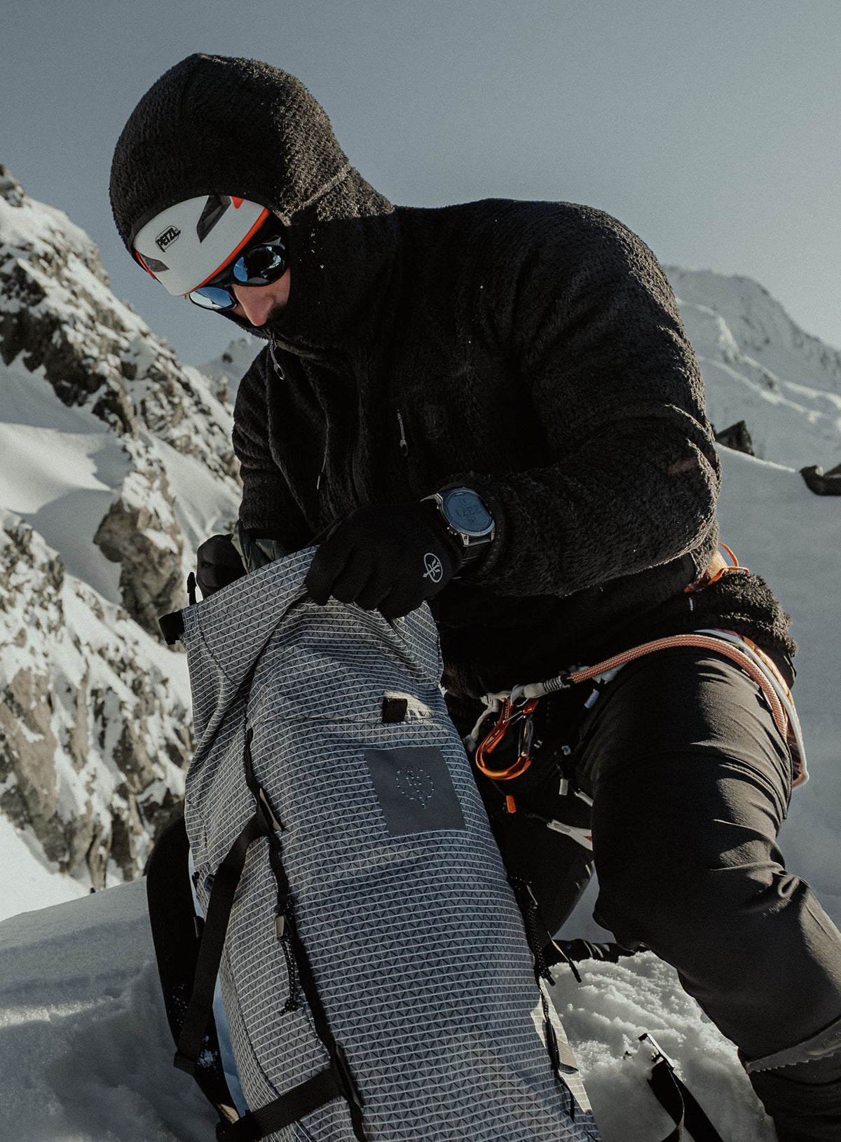 An in the field image of Phalanx Hooded Fleece in Obsidian Black (ITF)