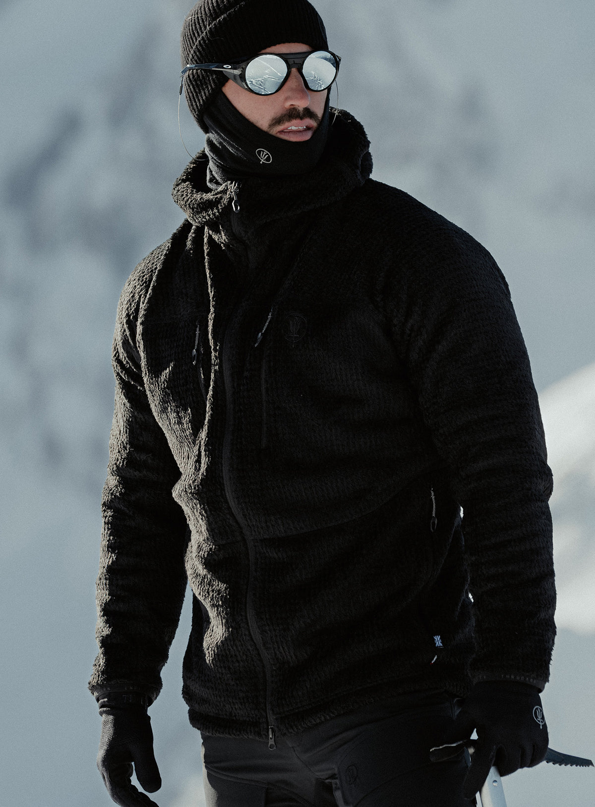 An in the field image of Phalanx Hooded Fleece in Obsidian Black (ITF)