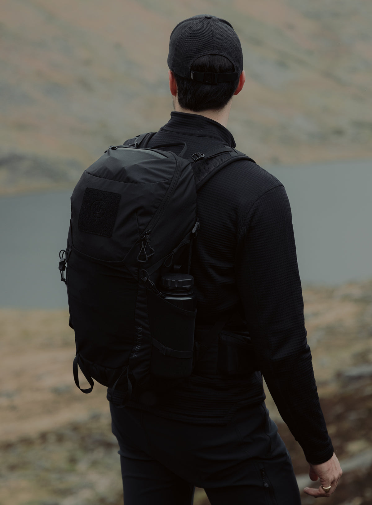 An in the field image of Pinnacle 28L Hiking Backpack in Obsidian Black (ITF)