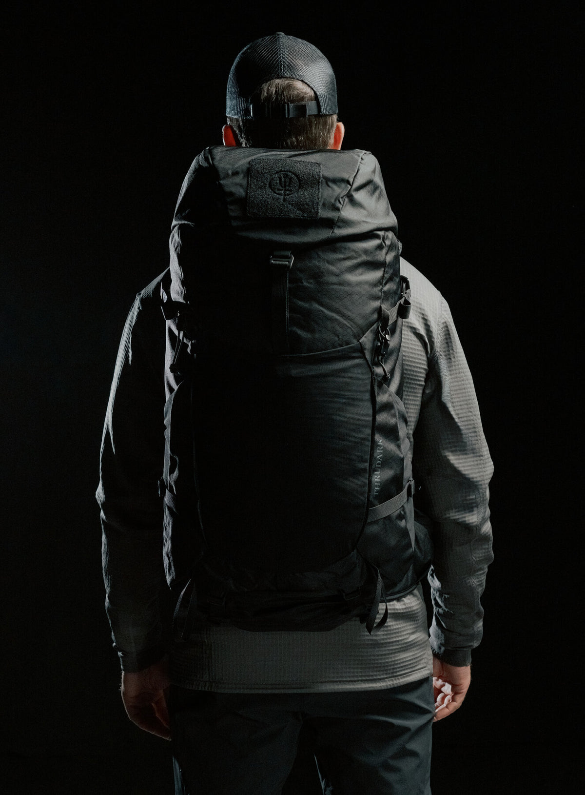 A creative studio shot of Pinnacle 42L Hiking Backpack in Obsidian Black (CS)
