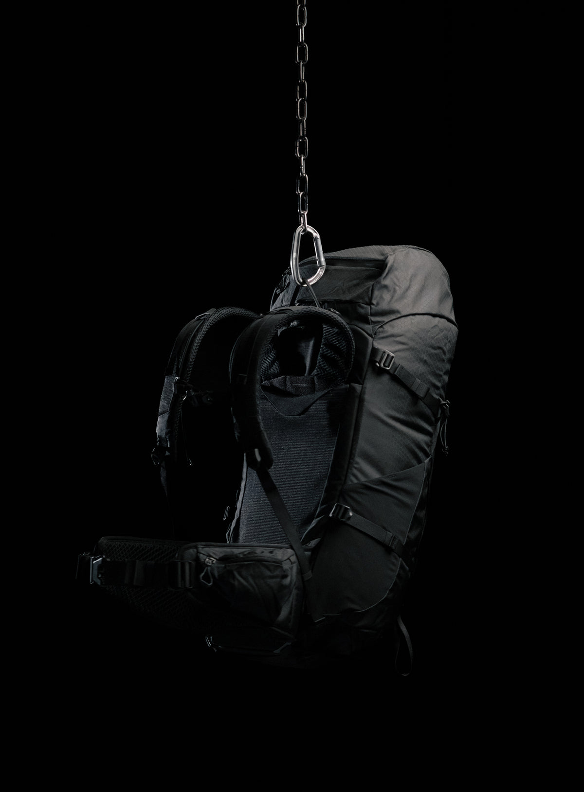 A creative studio shot of Pinnacle 42L Hiking Backpack in Obsidian Black (CS)