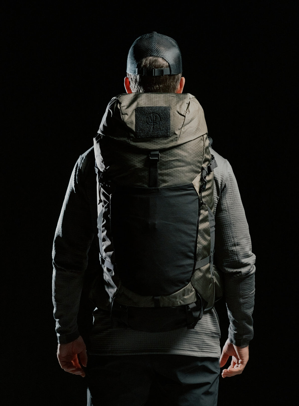 A creative studio shot of Pinnacle 42L Hiking Backpack in Olive Green (CS)