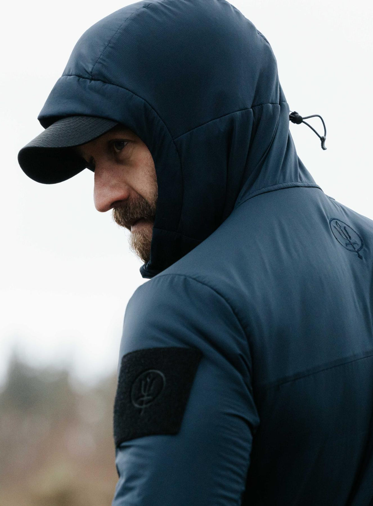An in the field image of Men's Wraith Hooded Jacket in Dark Sapphire (ITF)