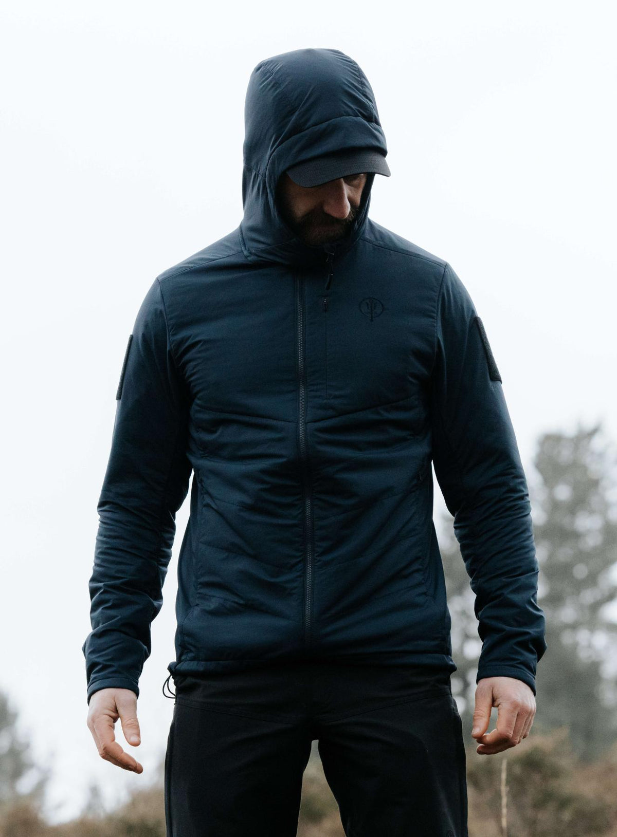 An in the field image of Men's Wraith Hooded Jacket in Dark Sapphire (ITF)